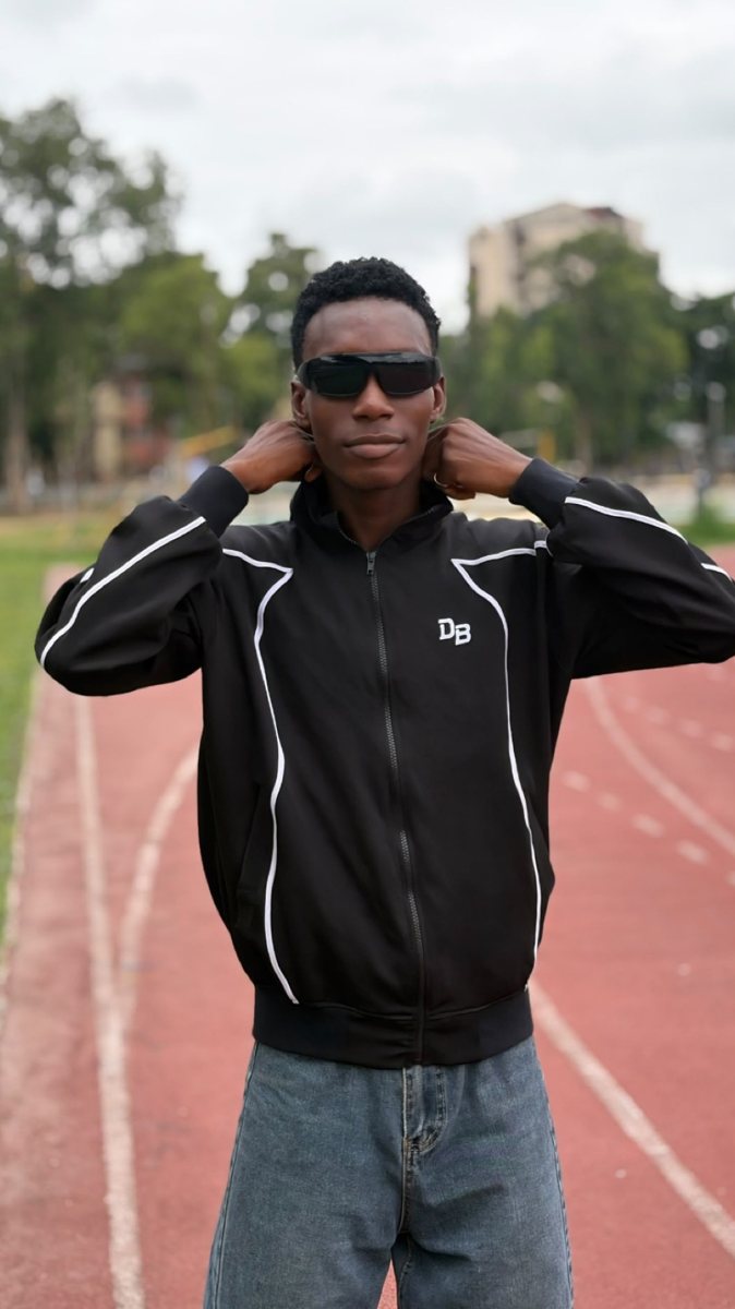 Abioye Abdulkhafid Olawale on a running track in a black De Bunar jacket