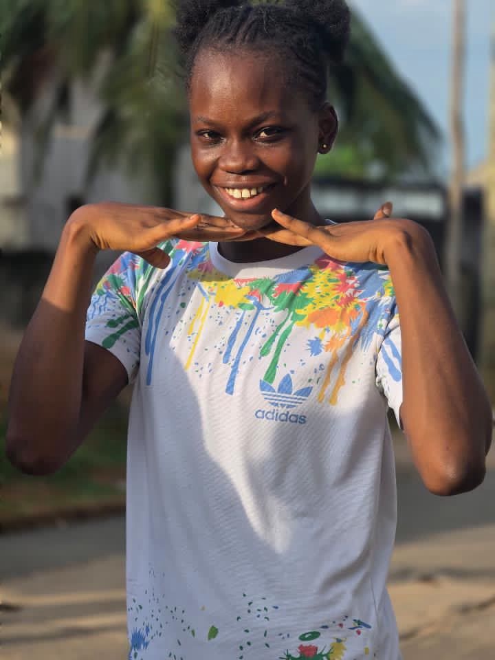 Young athlete smiling with her hands under her chin