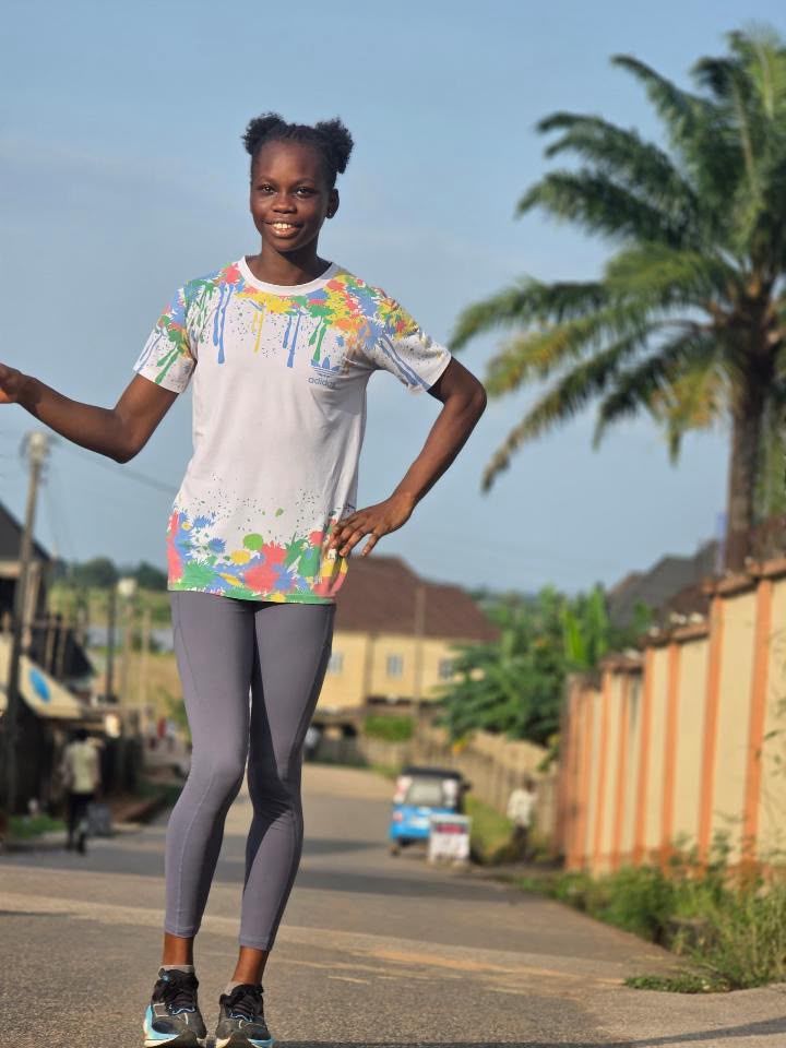 Young athlete standing on a street, smiling