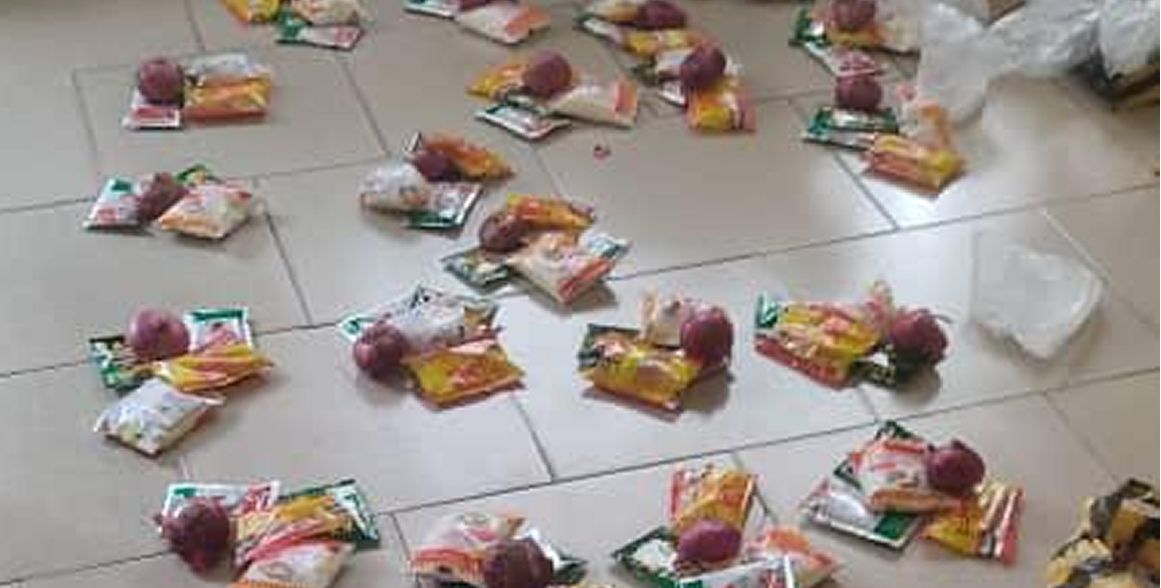 Food packages arranged on the floor ready for distribution