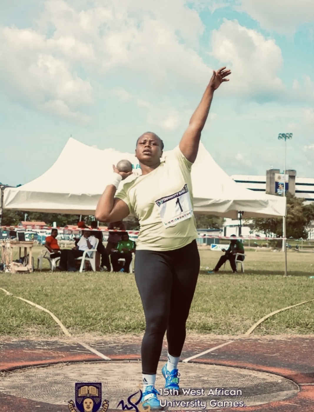 Shot putter supported by Kit Up an Athlete, mid-throw